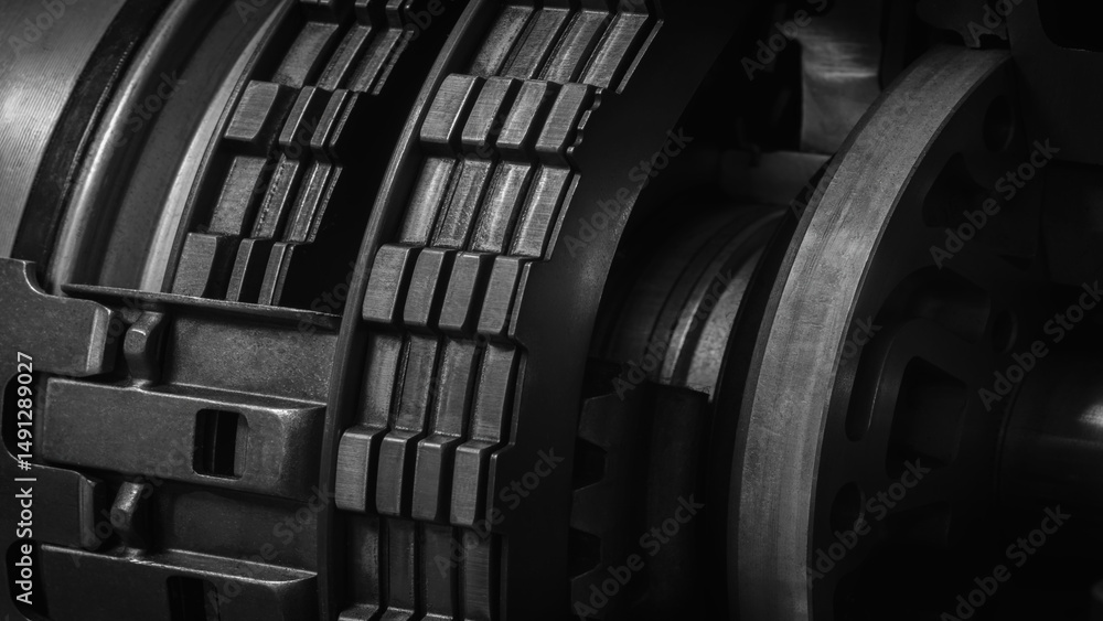 Poster a dark black close up of a machine with many gears and discs. concept of powerful industrial energy 