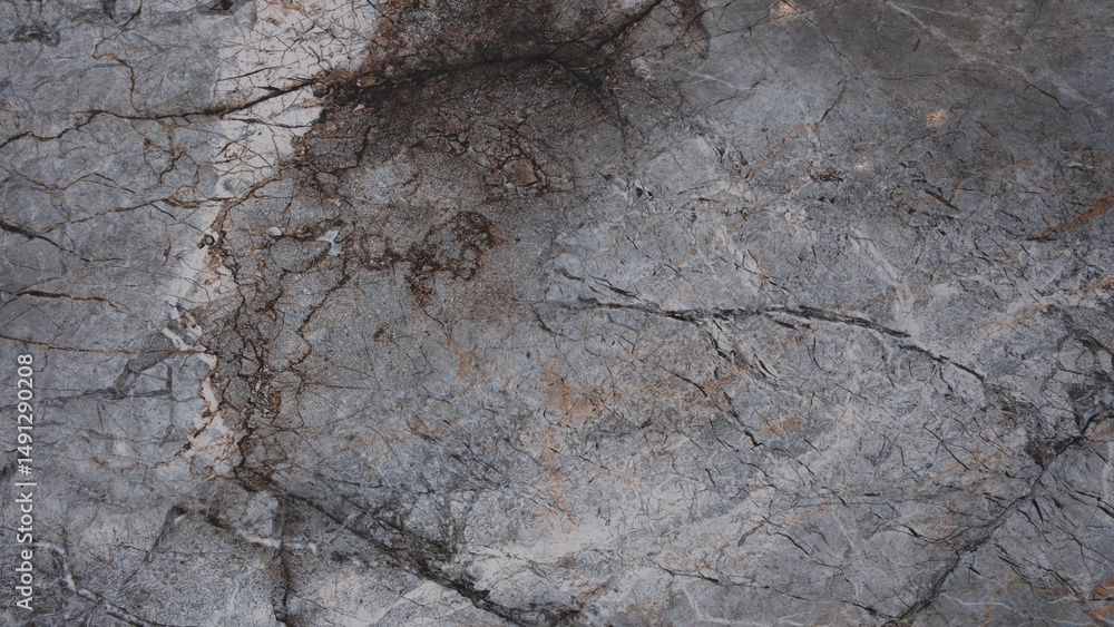 Poster a grey stone wall with a few cracks and holes. wall is rough and uneven, giving it a rugged appearan