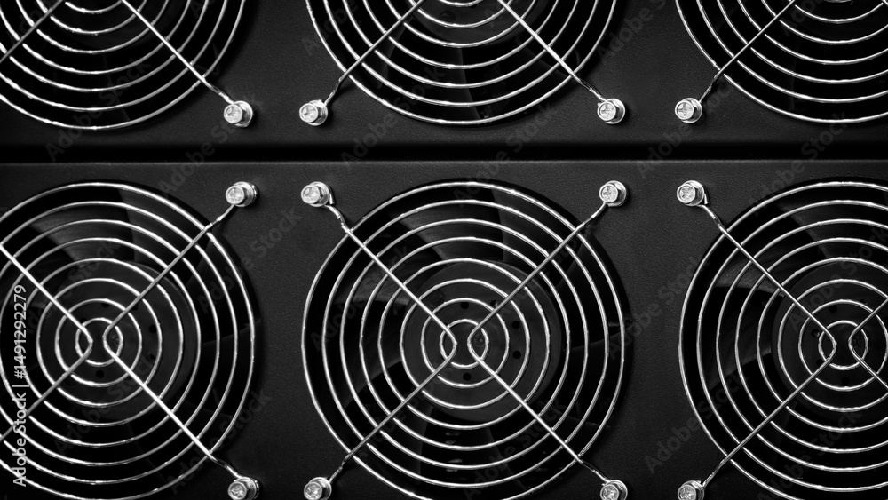 Poster a close up of a black computer fan with a silver mesh. the fan is surrounded by other fans, creating
