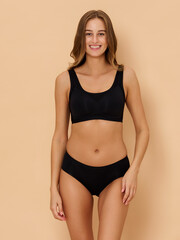 Obraz premium Girl model in underwear posing in studio on beige background.