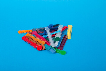 Model of jaw with braces on blue background.