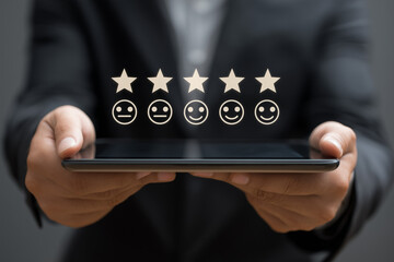 Businessman is using tablet to give five star feedback, showing satisfaction rating with excellent service