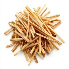 Dried, pale-yellow, slender plant pieces piled high