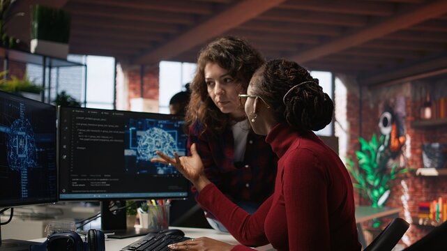 Teamworking engineers coding advanced AI algorithm and machine learning models enhancing automation. Employee talking with coworker in artificial intelligence Silicon Valley workspace, camera A