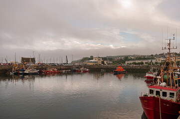 A large body of water with many boats docked at a pier