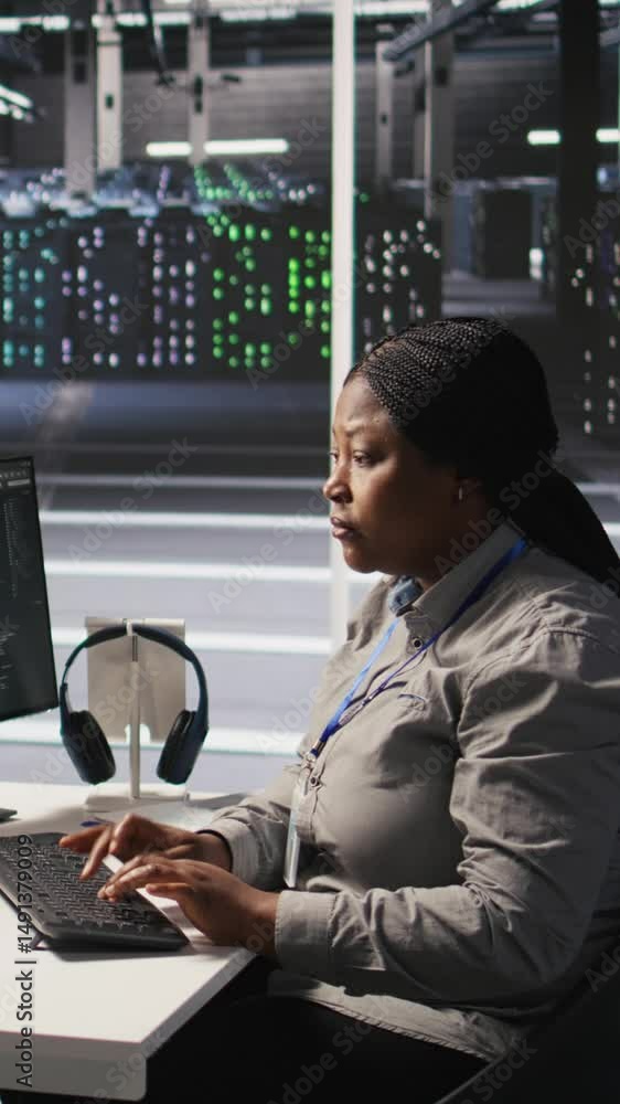 Poster vertical video data center system administrator using pc to monitor neural network ai visualization.