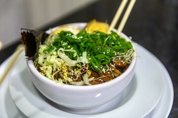 Traditional Japanese ramen or ramen with vegetable broth, grilled pork, oriental noodles and classic Japanese cuisine spices