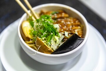 Traditional Japanese ramen or ramen with vegetable broth, grilled pork, oriental noodles and classic Japanese cuisine spices