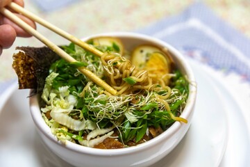 Traditional Japanese ramen or ramen with vegetable broth, grilled pork, oriental noodles and classic Japanese cuisine spices