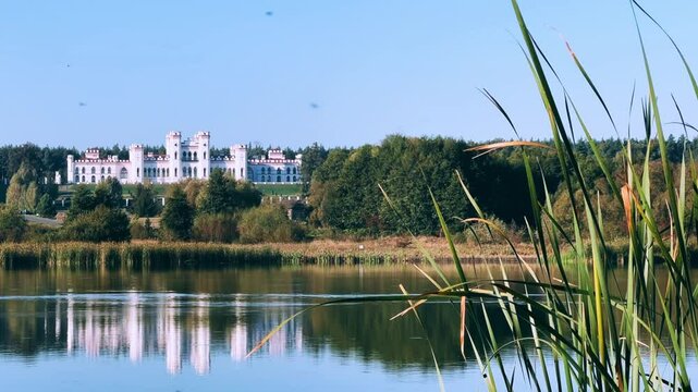 Belarus, Puslovsky Palace, September 5, 2024: Kossovsky Autumn Castle on the shore of Lake Albertino. An old castle in Kosovki in autumn. An architectural monument in the style of English Neo-Gothic.