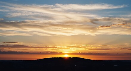 Fototapeta premium Sunset Over Hill with Clouds