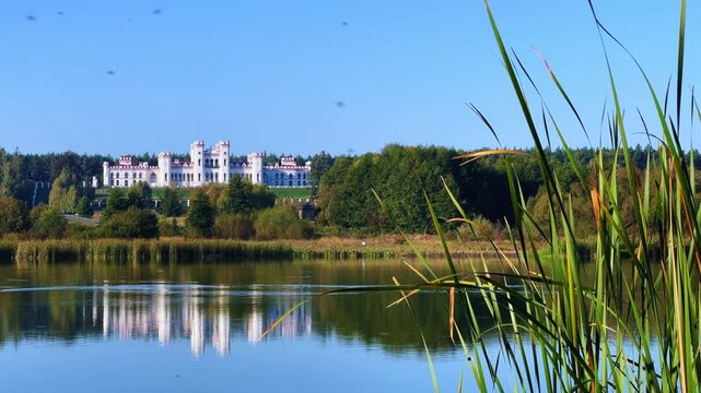 Belarus, Puslovsky Palace, September 5, 2024: Kossovsky Autumn Castle on the shore of Lake Albertino. An old castle in Kosovki in autumn. An architectural monument in the style of English Neo-Gothic.