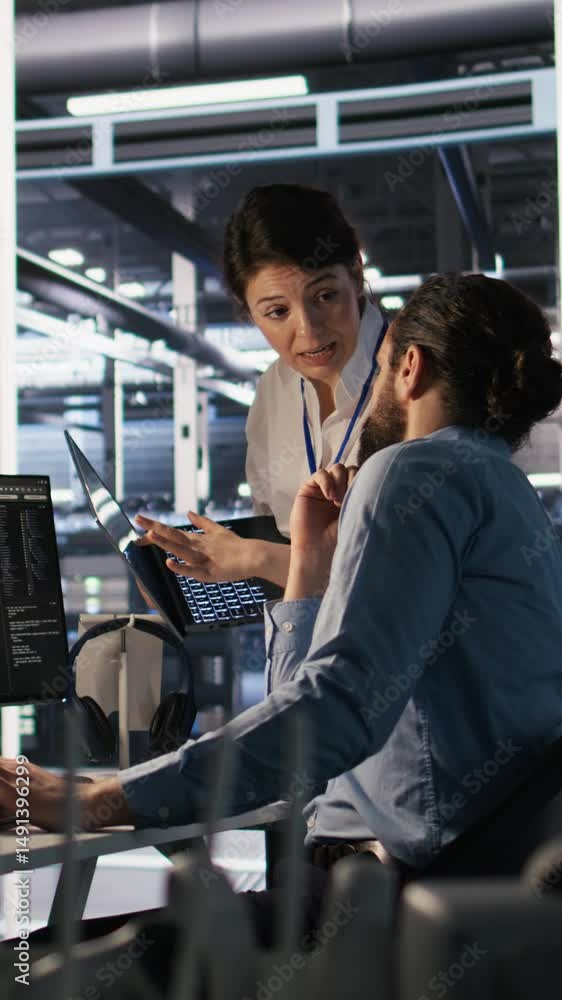Poster vertical video data center admins working together, collaborating on neural network software develop