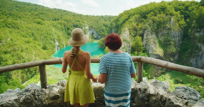 Two women enjoy a scenic overlook at Plitvice Lakes National Park Croatia during summer vacation