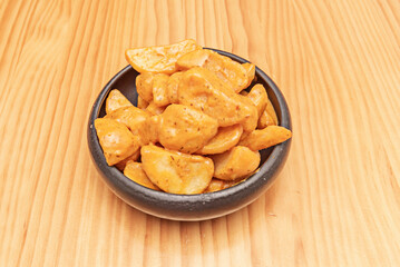 Patatas bravas are served hot as a tapa or appetizer