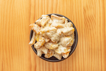 Patatas bravas are served hot as a tapa or appetizer, paired with a glass of wine or caña. They originated in the city of Madrid