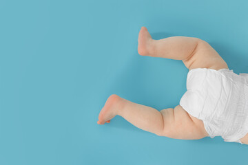Cute little baby crawling on light blue background, top view. Space for text
