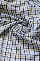 Textile Close-Up of Soft Plaid Cotton Fabric with Artistic Folds and Wrinkles, Blue and Olive Checkered Pattern for Clothing or Decoration