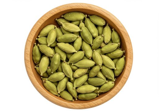 A wooden bowl filled with a generous amount of aromatic cardamom pods viewed above