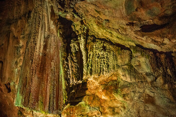 A close-up view of a limestone cave, filled with colorful,curious,wonderful. Lighting enhance texture and geological beauty.