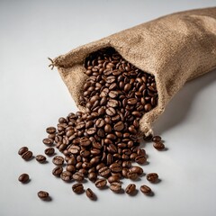 Roasted coffee beans spilling from bag on white background.