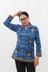 Confused Indonesian civil servant woman standing while holding her head. Isolated on white