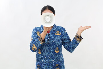 Young asian civil servant woman take megaphone covered face and show something to you isolated on...