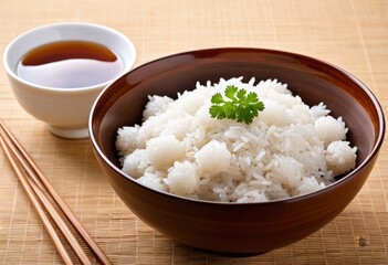 The table had a bowl of rice and chopsticks