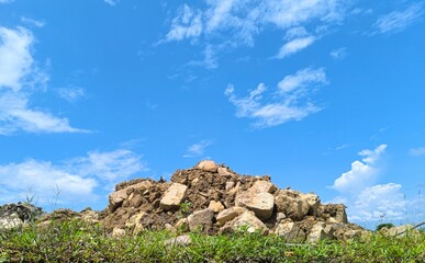 pile of rock material resulting from excavation by heavy equipment excavator