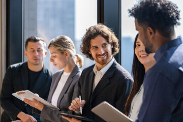 Team of diversity business people are discussing over the new strategic strategy project on investment real estate while brainstorming around the office building for new project and planning