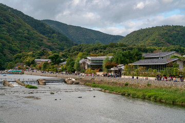 Boating on the Katsura River in the Rankyo Gorge in the favorite vacation spot of Kyoto residents in Arashiyama district on a sunny autumn day, Kyoto, Japan