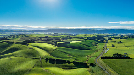 Rural country road winding its way through agriculture and farm land in the heartland of the South Island NZ