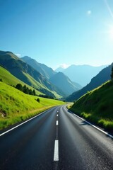 Fototapeta premium Asphalt road winding through a picturesque valley, surrounded by lush green hills and a vibrant blue sky, under the radiant sunlight.