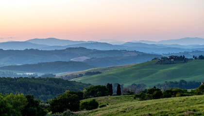 Beautiful rolling hills with lush greenery under a colorful sunrise sky