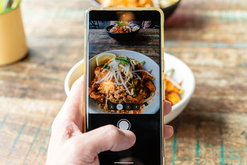 POV shot of taking photo of a meal using the camera app of a smartphone