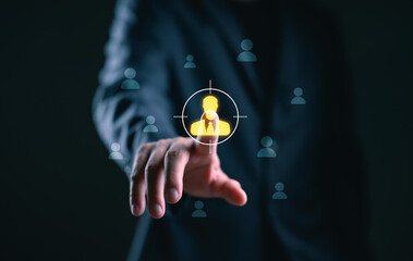 Target audience and recruitment concept. Businessman pressing highlighted user icon on virtual interface to select ideal candidate or customer profile in digital business strategy.
