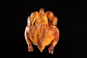 A whole delicious roasted chicken on table.