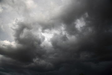 Fototapeta premium Dramatic dark storm thundercloud rain clouds on black sky background. Dark thunderstorm clouds rainny landscape. Meteorology danger windstorm disaster climate. Dark cloudscape storm disaster gray sky