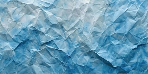Obraz premium A crumpled piece of blue paper with a white background.