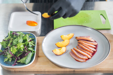 The chef serves roast duck. 