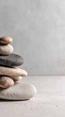 Stacked stones balance in studio shot for zen meditation and wellness practices on neutral background with copy space