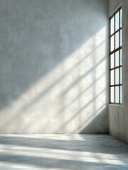 Obraz premium Interior scene of empty room with sunlight streaming through window casting shadows on textured wall and floor