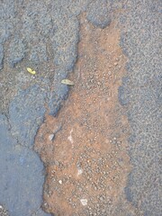Distressed Asphalt Surface with Exposed Gravel