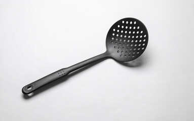 Black kitchen spatula colander on white background