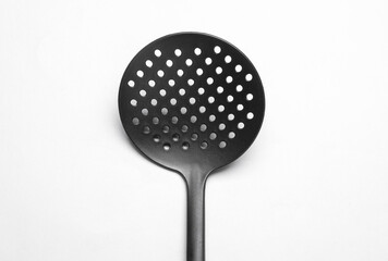 Black kitchen spatula colander on white background