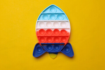 Pop it in the shape of a space shuttle on yellow background