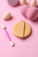 Set of cosmetic sponges blenders for makeup and accessories on pink background