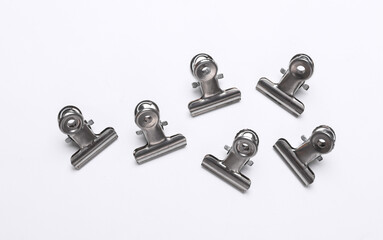 Metallic binders clips on white background