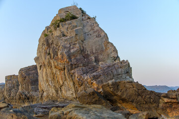 夕日に照らされる橋杭岩の岩壁