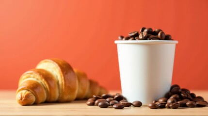 A Buttery Croissant and a Cup of Roasted Coffee Beans on a Wooden Surface Against a Warm Background